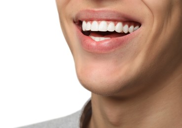 Happy young man on white background, closeup. Dental veneers