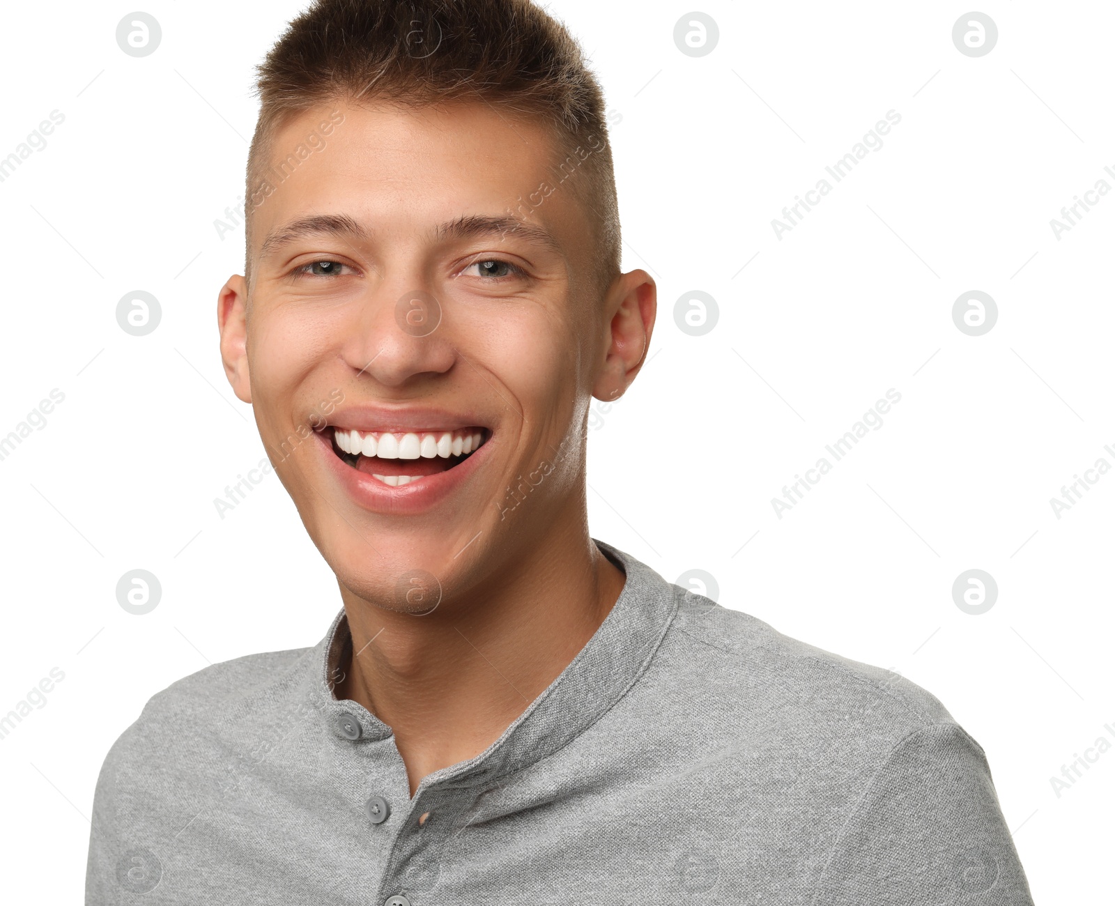 Photo of Happy young man on white background. Dental veneers