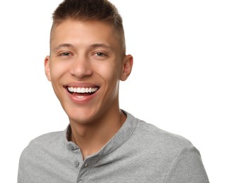 Happy young man on white background. Dental veneers