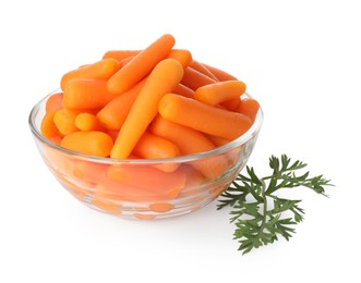 Baby carrots in bowl and green leaf isolated on white