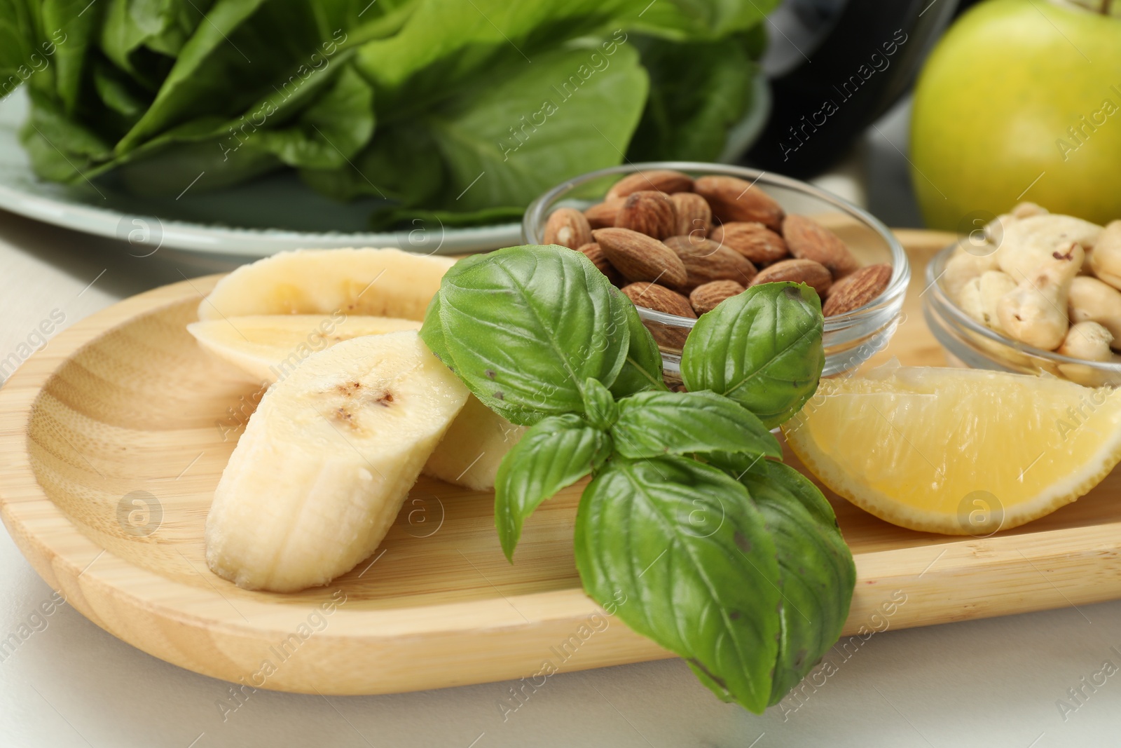 Photo of Fresh ingredients for smoothie on white marble table, closeup