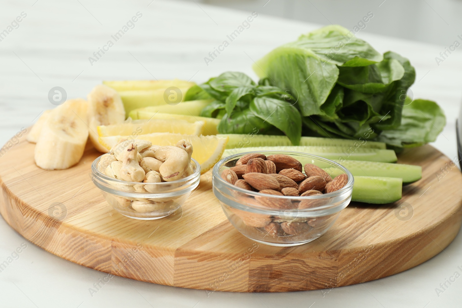 Photo of Fresh ingredients for smoothie on white marble table, closeup