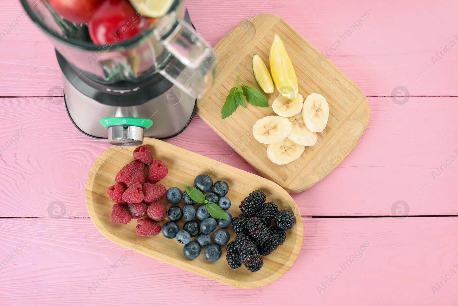 Photo of Blender and fresh ingredients on pink wooden table, top view