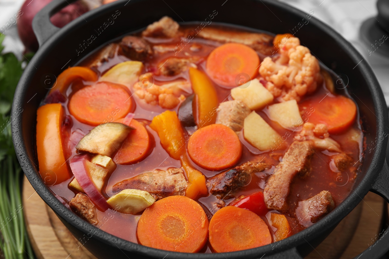 Photo of Tasty homemade stew with vegetables on table, closeup