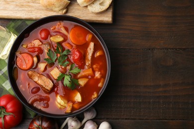 Tasty homemade stew with vegetables on wooden table, flat lay. Space for text