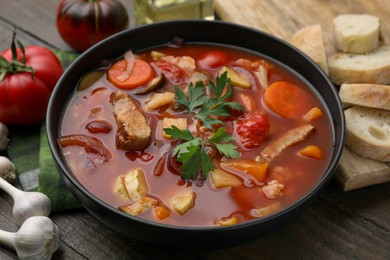 Photo of Tasty homemade stew with vegetables on wooden table, closeup