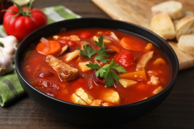 Photo of Tasty homemade stew with vegetables on wooden table, closeup