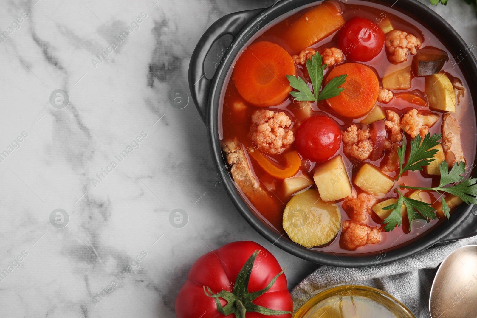 Photo of Tasty homemade stew with vegetables on white marble table, flat lay. Space for text