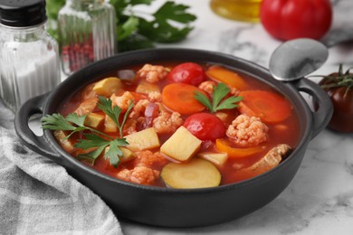 Photo of Tasty homemade stew with vegetables on white marble table, closeup