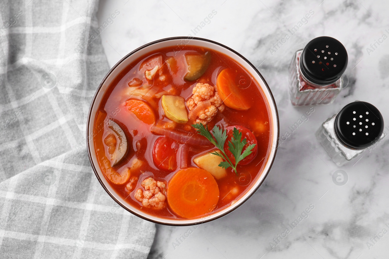 Photo of Tasty homemade stew with vegetables on white marble table, flat lay