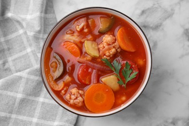 Photo of Tasty homemade stew with vegetables on white marble table, top view