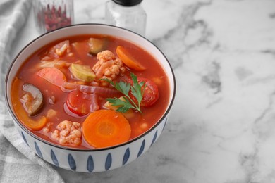 Tasty homemade stew with vegetables on white marble table, closeup. Space for text