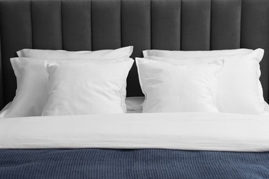 Many soft pillows on bed at home