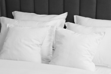 Photo of Many soft pillows on bed at home, closeup