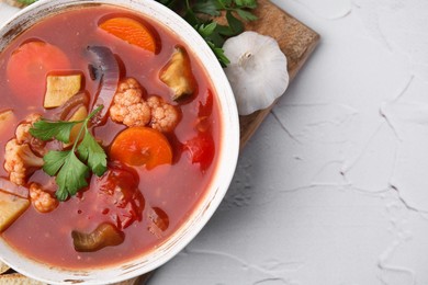 Delicious homemade stew in bowl on light table, top view