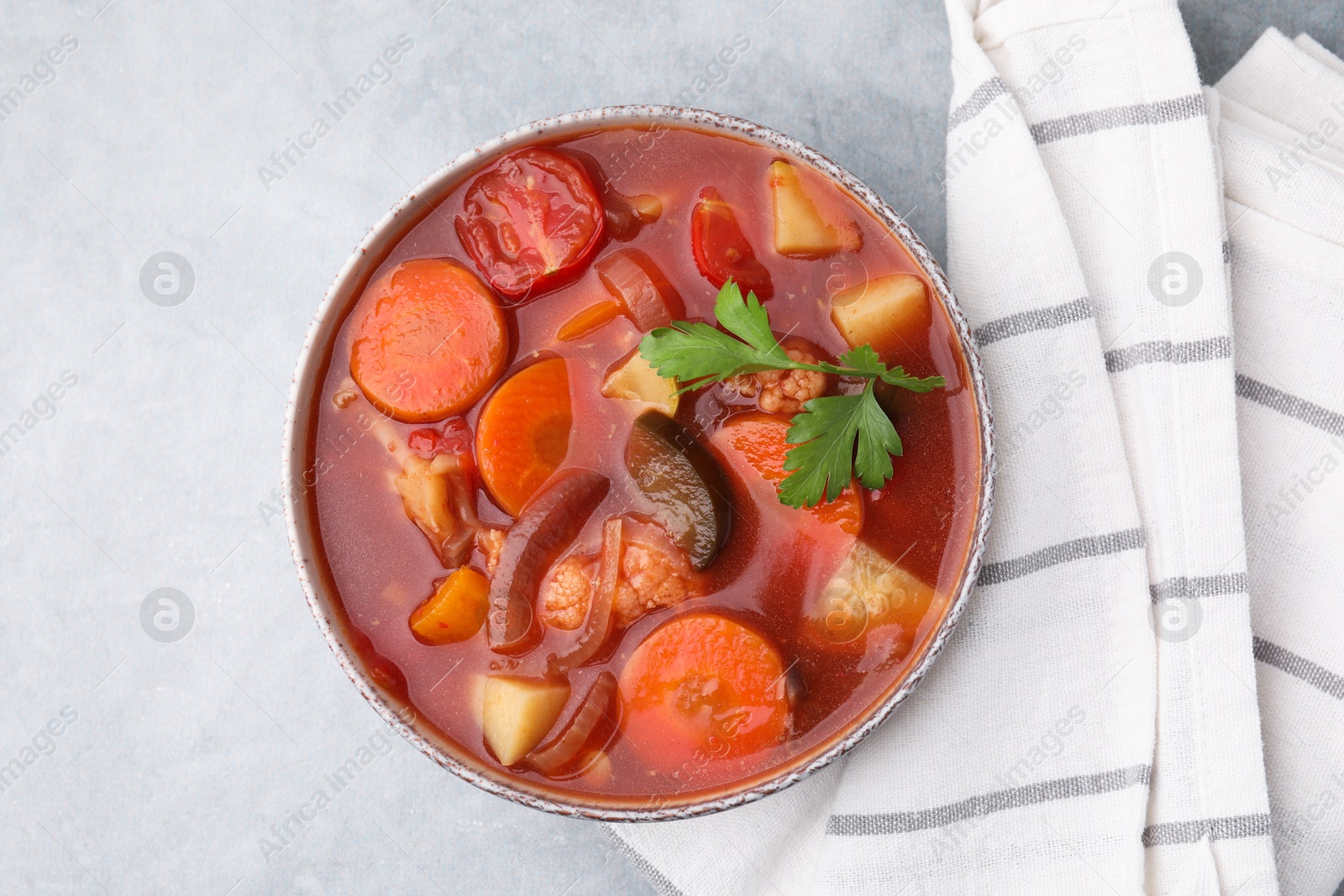 Photo of Delicious homemade stew in bowl on light table, top view