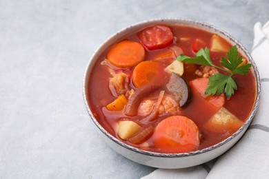 Photo of Delicious homemade stew in bowl on light table, closeup