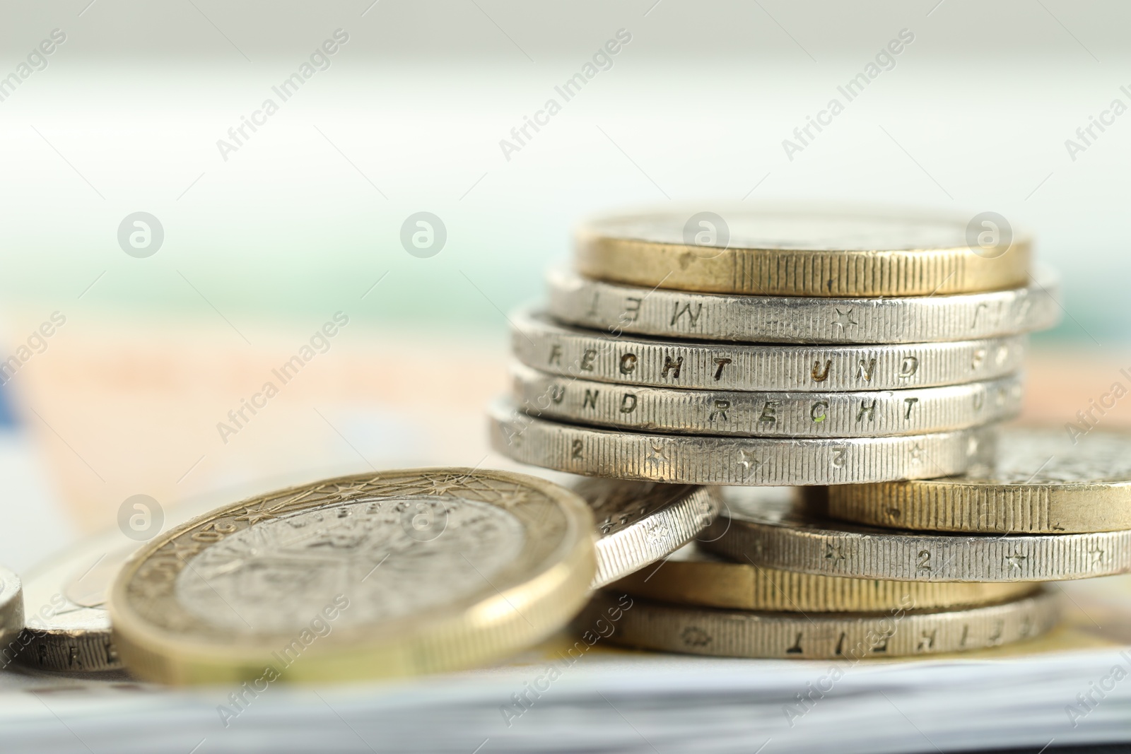 Photo of Many euro coins on blurred background, closeup