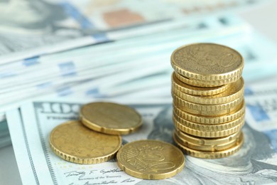 Photo of Stacked euro coins on dollar banknotes, closeup