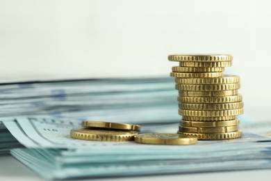 Photo of Stack of euro coins and dollar banknotes on white background, closeup