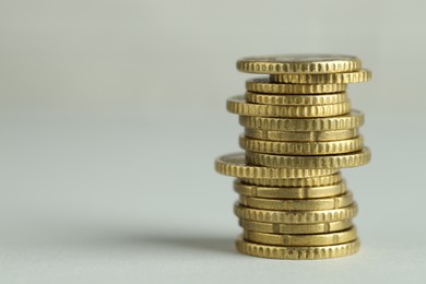 Photo of Stack of euro coins on grey background, space for text