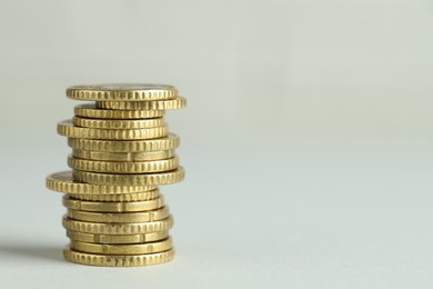 Photo of Stack of euro coins on grey background, space for text