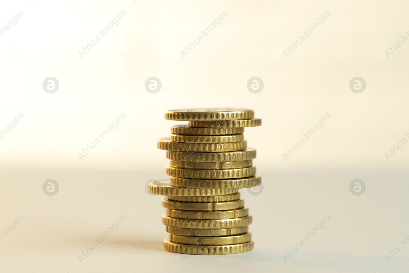 Photo of Stack of euro coins on beige background