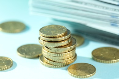 Photo of Stack of euro coins on light blue background, closeup