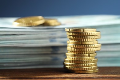 Photo of Stack of euro coins on wooden table, closeup