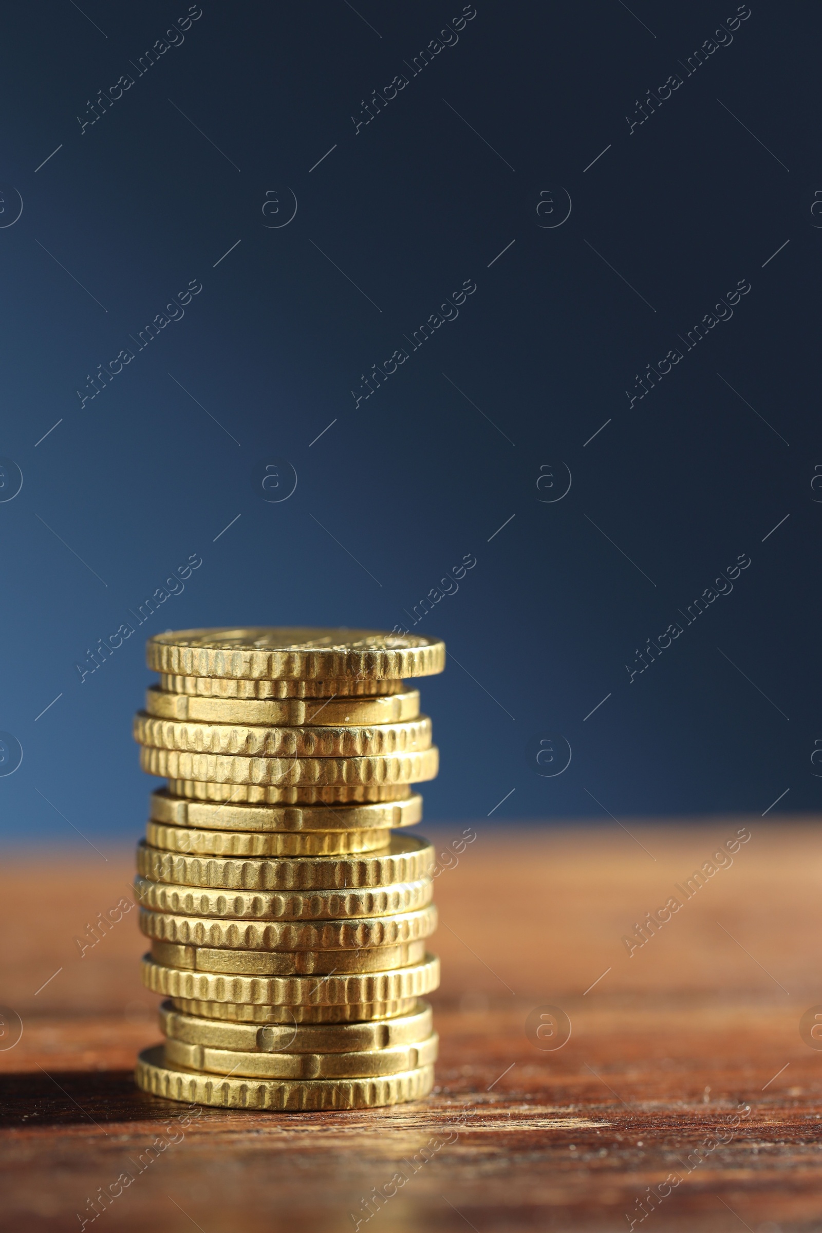 Photo of Stack of euro coins on wooden table