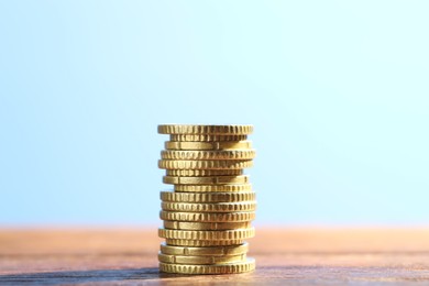 Photo of Stack of euro coins on wooden table