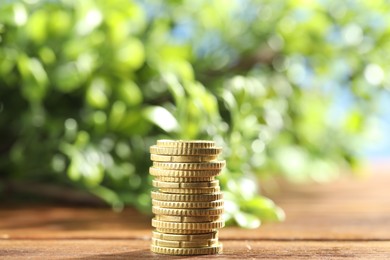 Photo of Stack of euro coins on wooden table