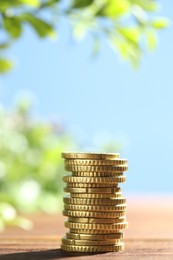 Photo of Stack of euro coins on wooden table