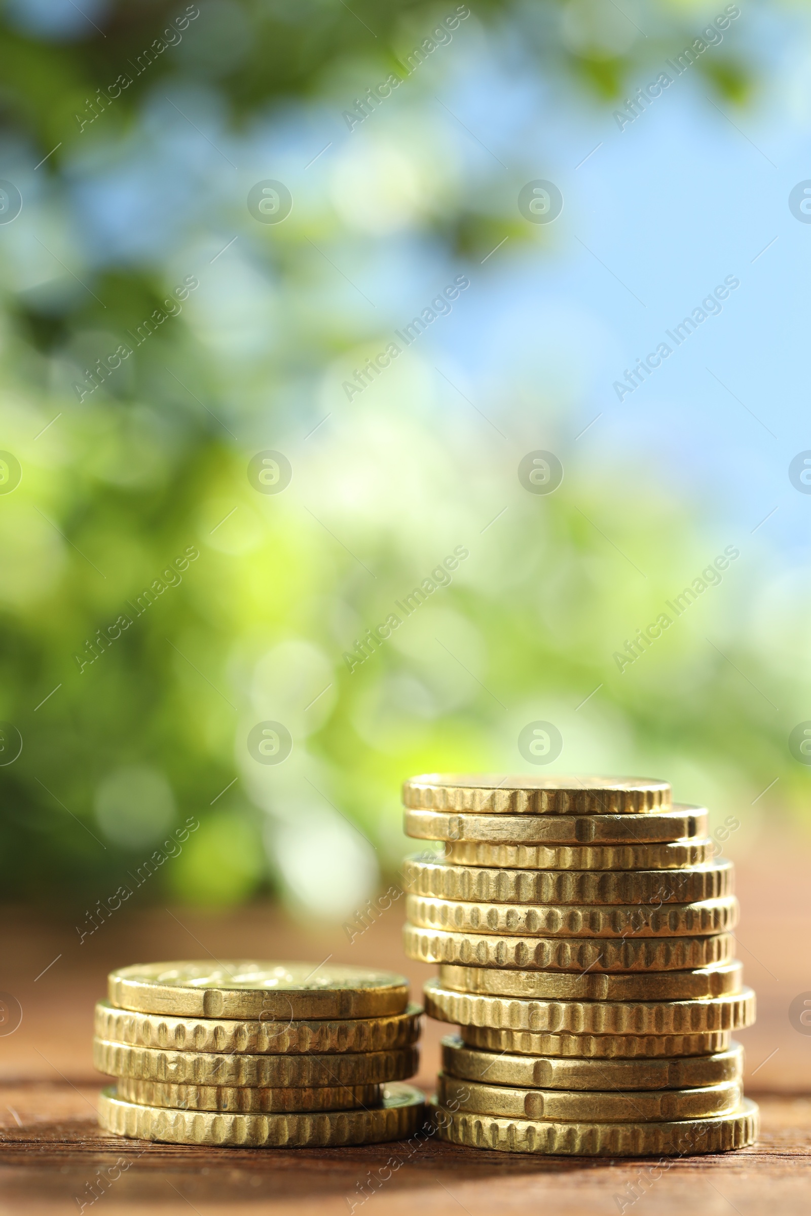 Photo of Stacks of euro coins on wooden table