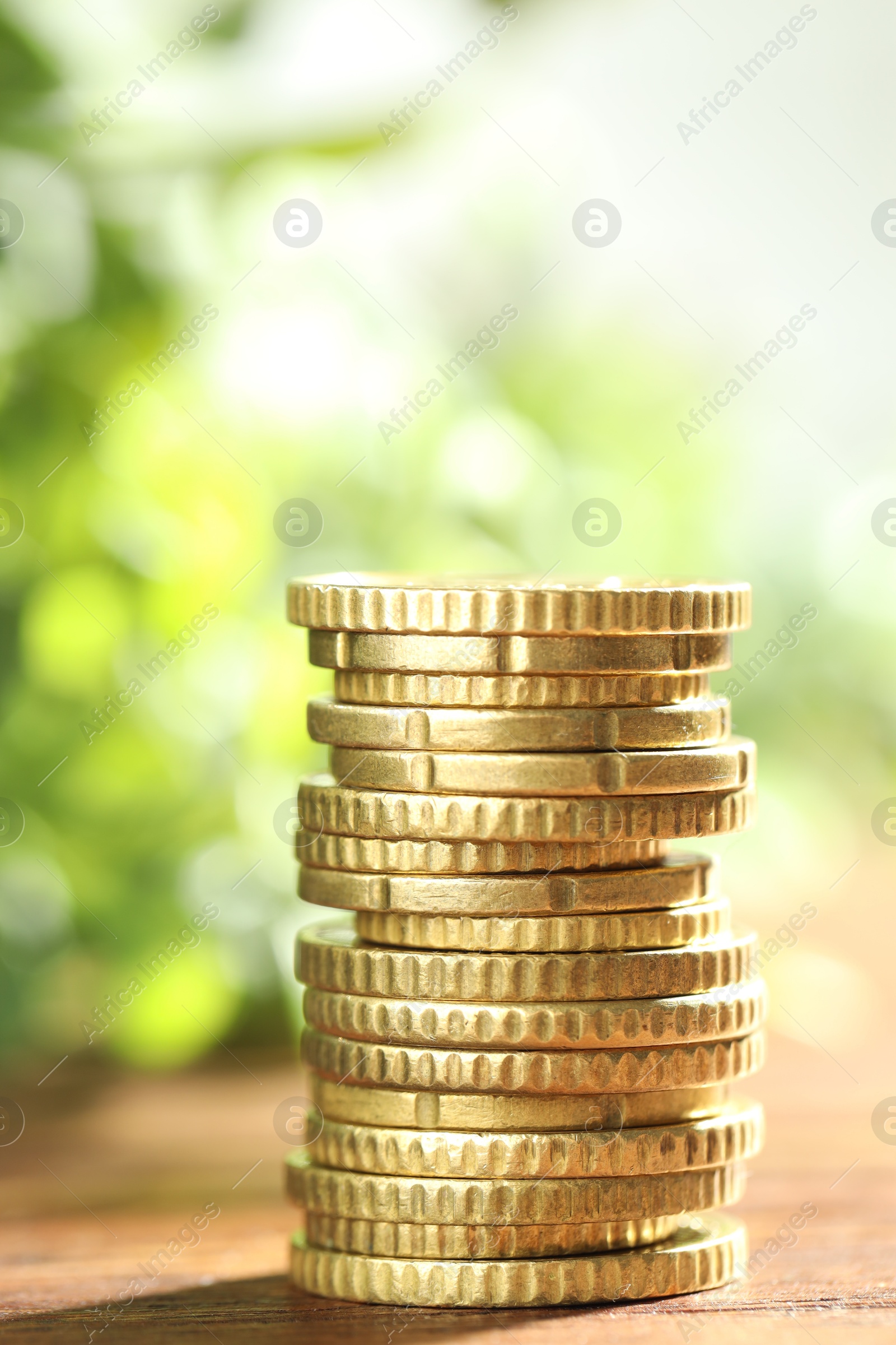 Photo of Stack of euro coins on wooden table