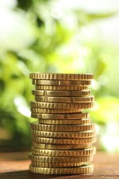 Photo of Stack of euro coins on wooden table