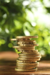 Photo of Stack of euro coins on wooden table