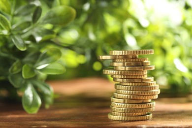 Photo of Stack of euro coins on wooden table