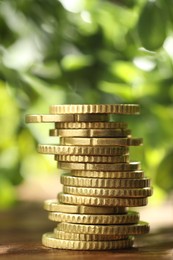 Photo of Stack of euro coins on wooden table