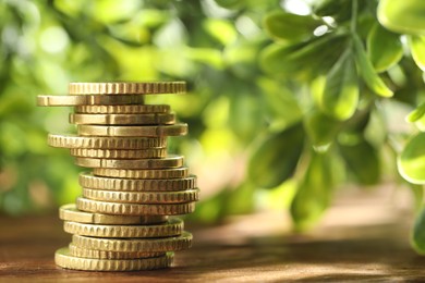 Photo of Stack of euro coins on wooden table