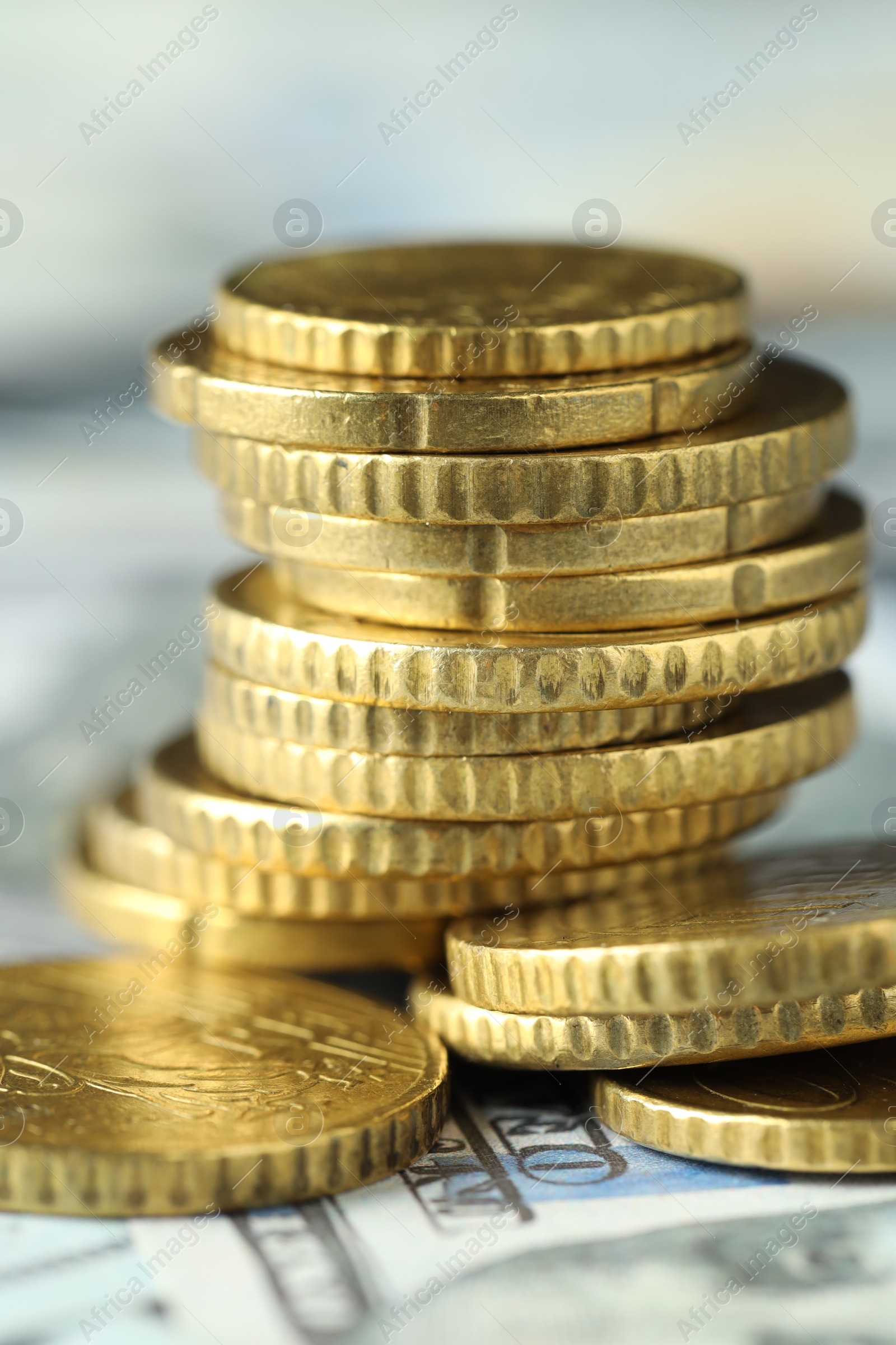 Photo of Many euro coins on dollar banknotes, closeup