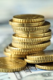 Photo of Many euro coins on dollar banknotes, closeup