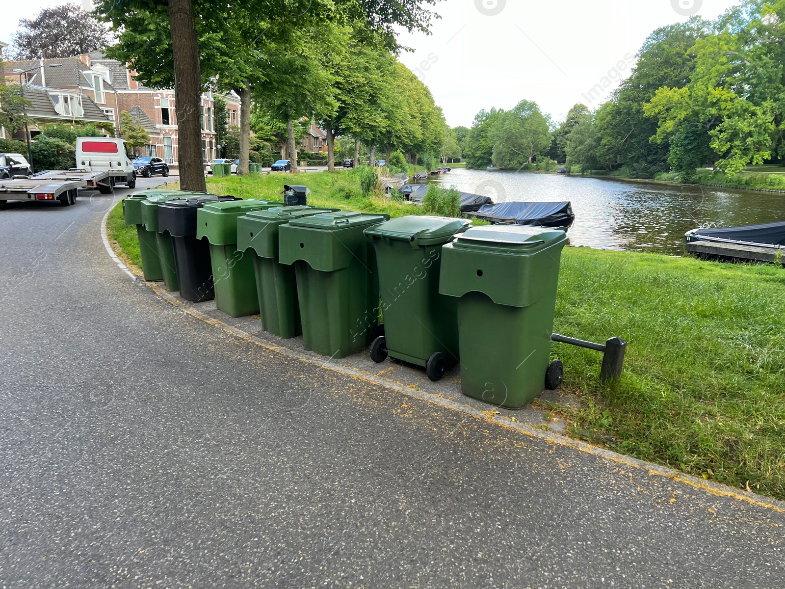 Photo of Many green trash bins on city street