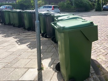 Many green trash bins on city street