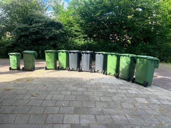 Many green trash bins on city street