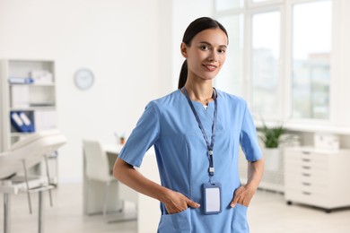 Photo of Portrait of smiling nurse in clinic. Space for text