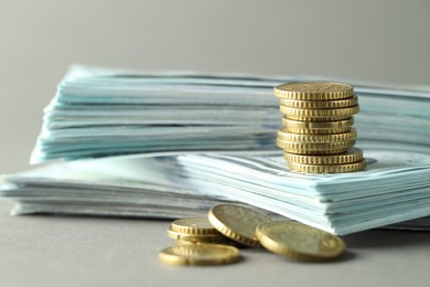 Photo of Stacked of euro coins and dollar banknotes on grey background, closeup