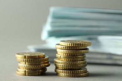 Photo of Stacked of euro coins on grey background, closeup