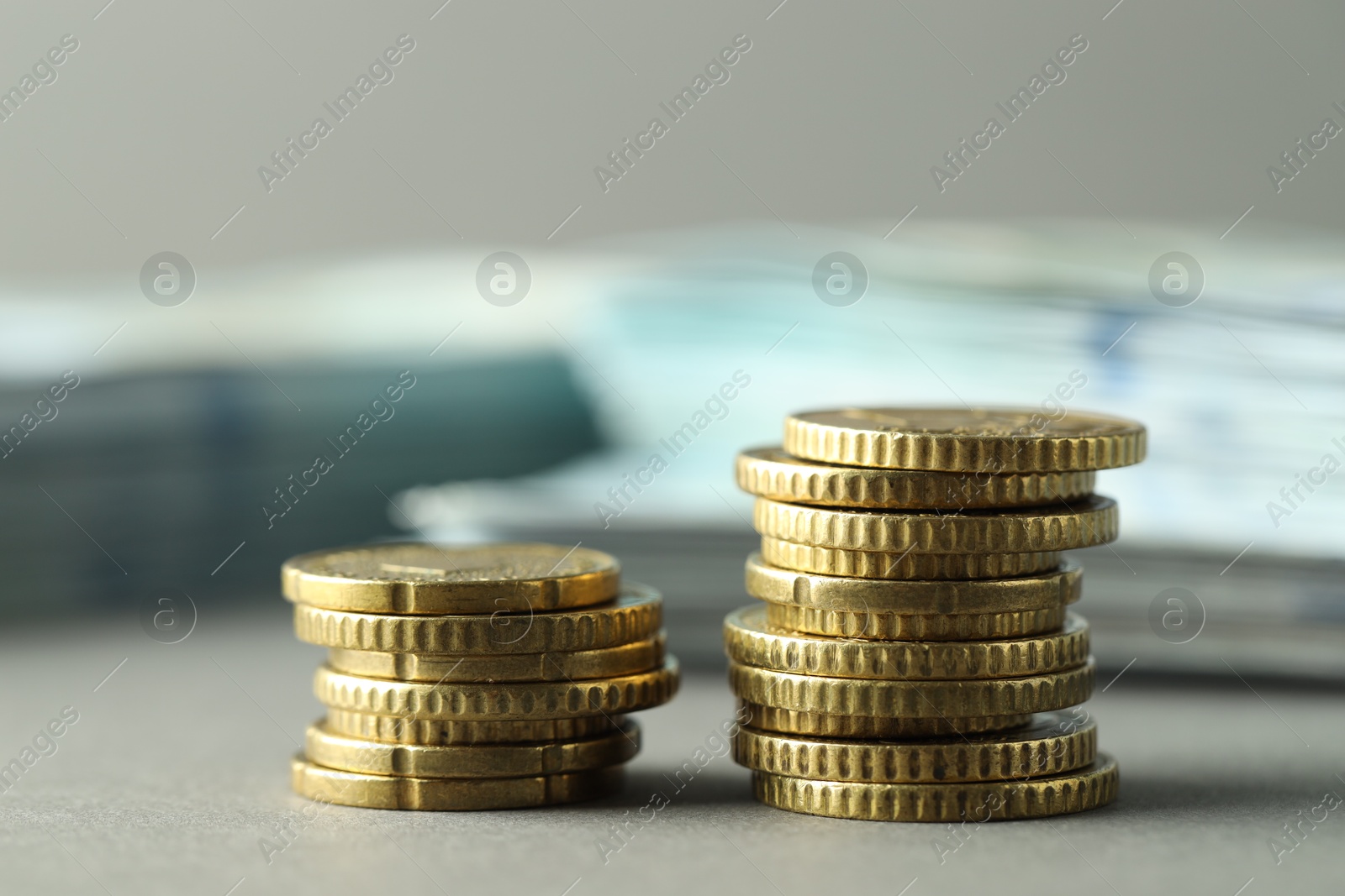 Photo of Stacked of euro coins on grey background, closeup