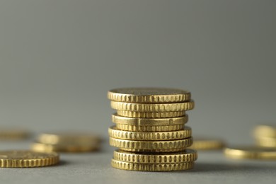 Photo of Stack of euro coins on grey background, closeup